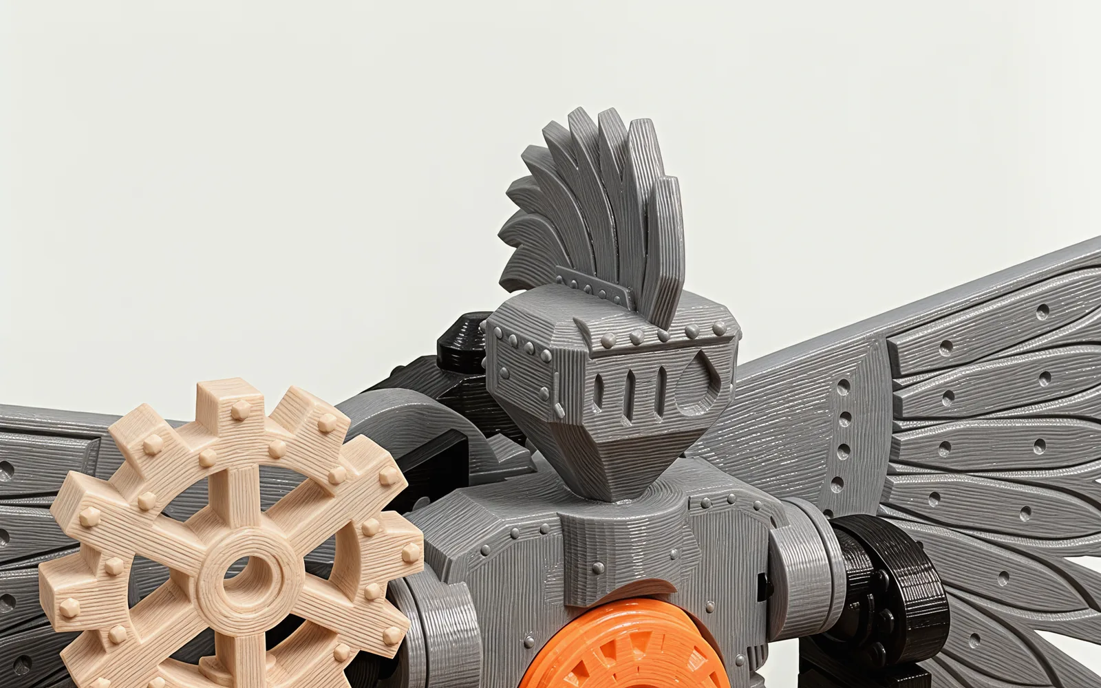 The crested, riveted helm with its slotted visor and crescent eye, beside the sun-gear head of the staff and the root of a wing.