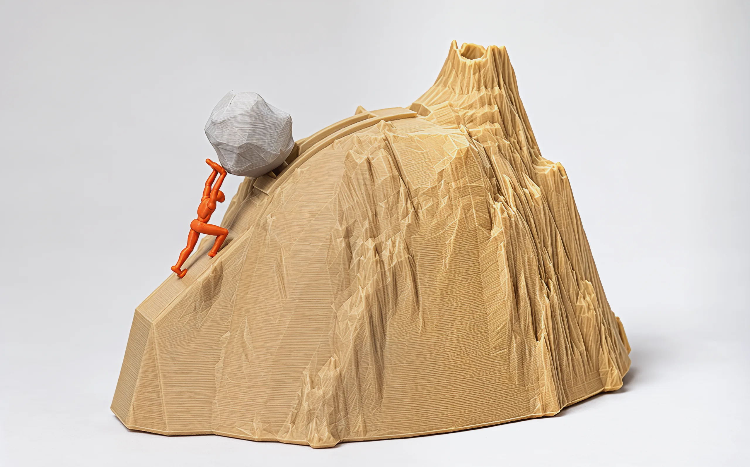 The whole piece on a pale grey backdrop: a sandstone mountain with a jagged crag peak, the trail curving over its crest, the terracotta figure and the pale boulder at its foot