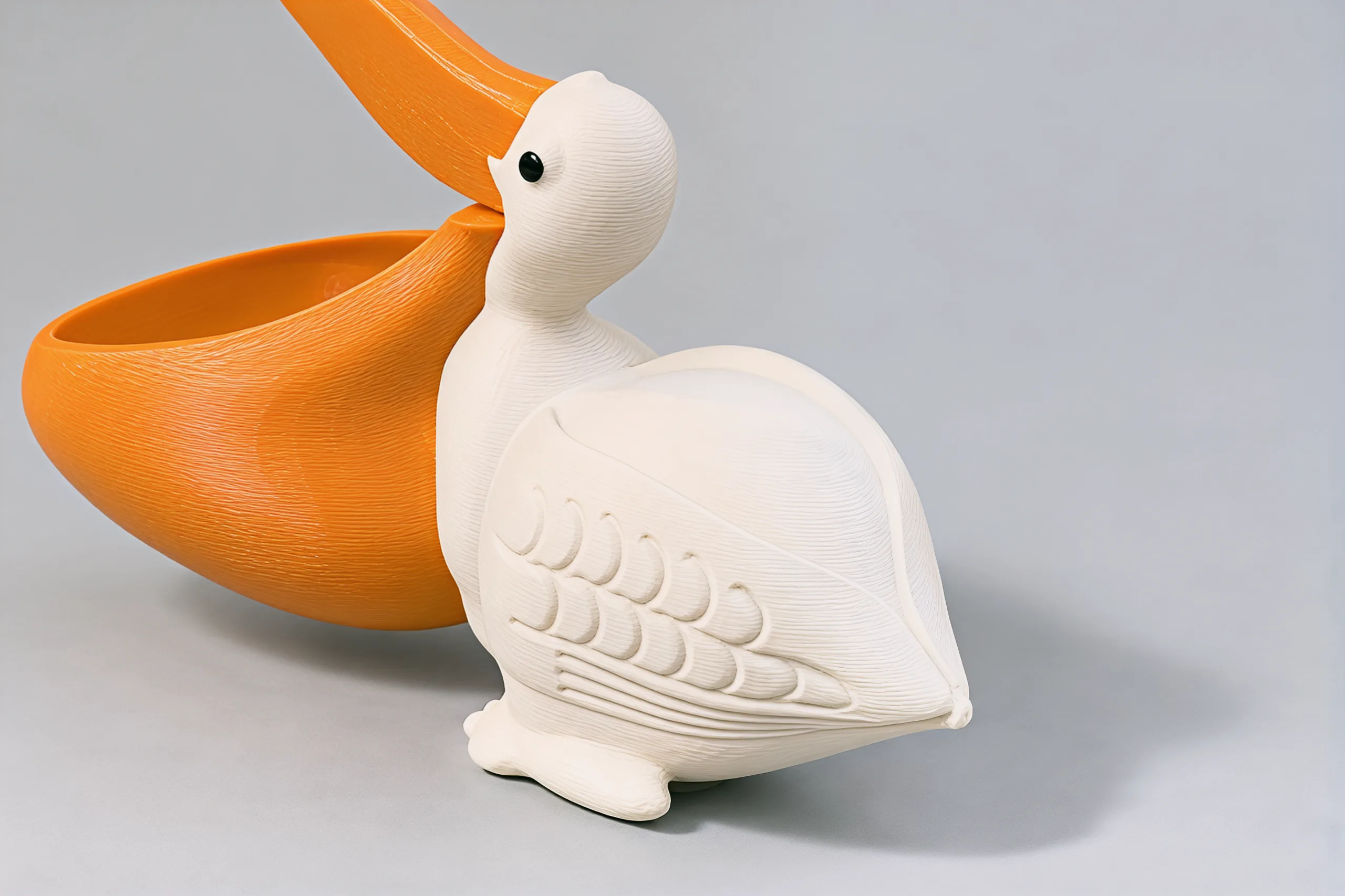 The folded left wing seen from behind the shoulder, rows of carved feathers running back to the tail