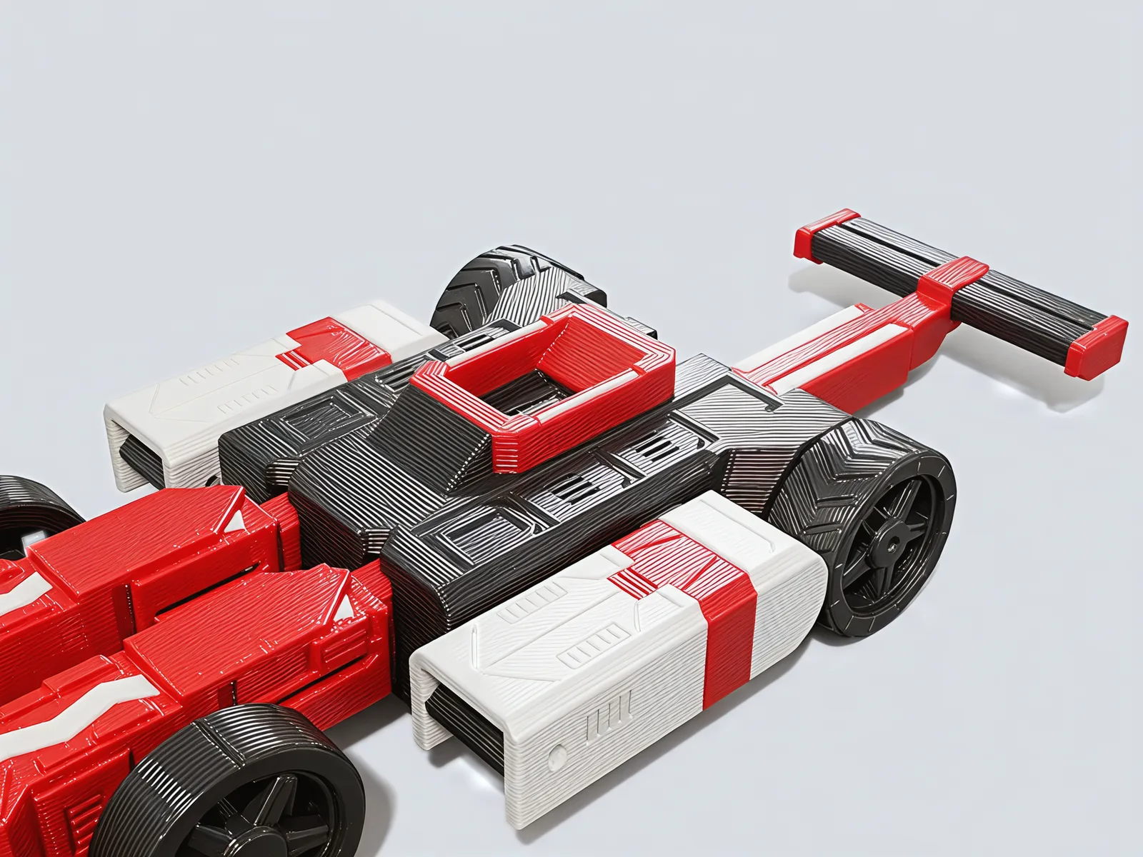 Car mode from above the cockpit: the red halo over the gunmetal body, white sidepods on both sides and the nose reaching out to the front wing.