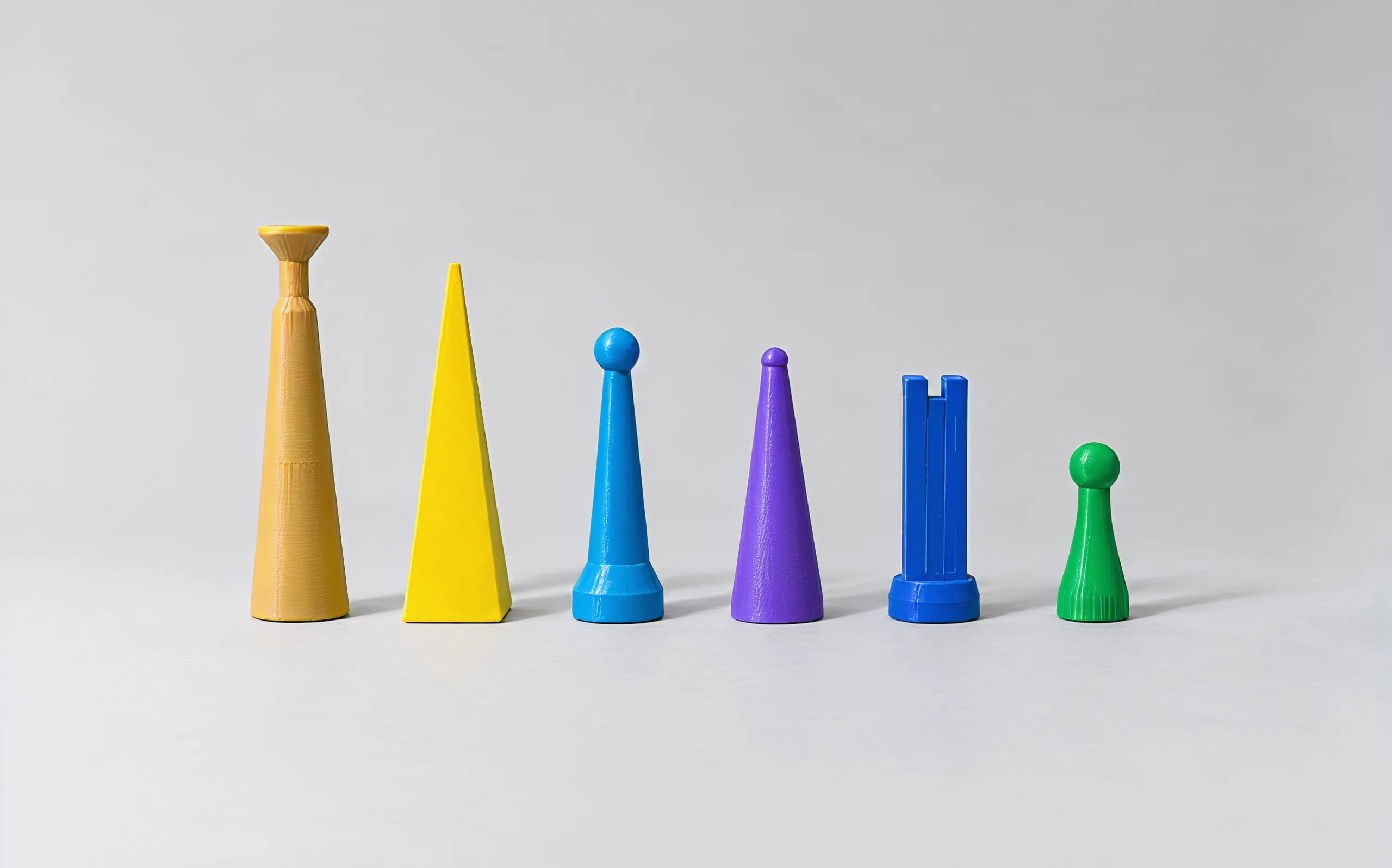 The six cool-side shapes in a row from tallest to shortest: tan king, yellow queen, blue bishop, purple knight, blue rook, green pawn