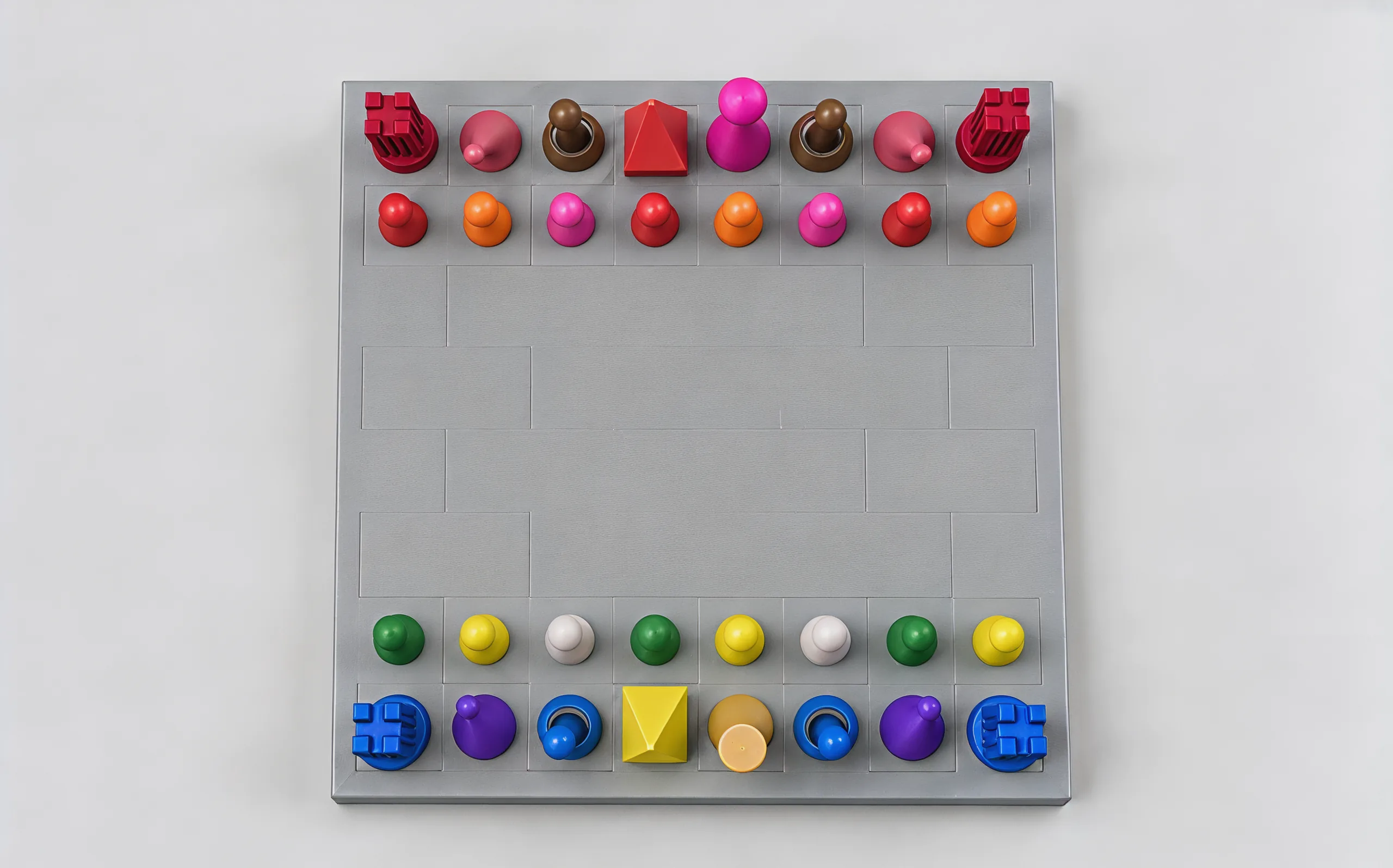The set from straight above: the warm pieces along the top edge, the cool pieces along the bottom, the empty squares between