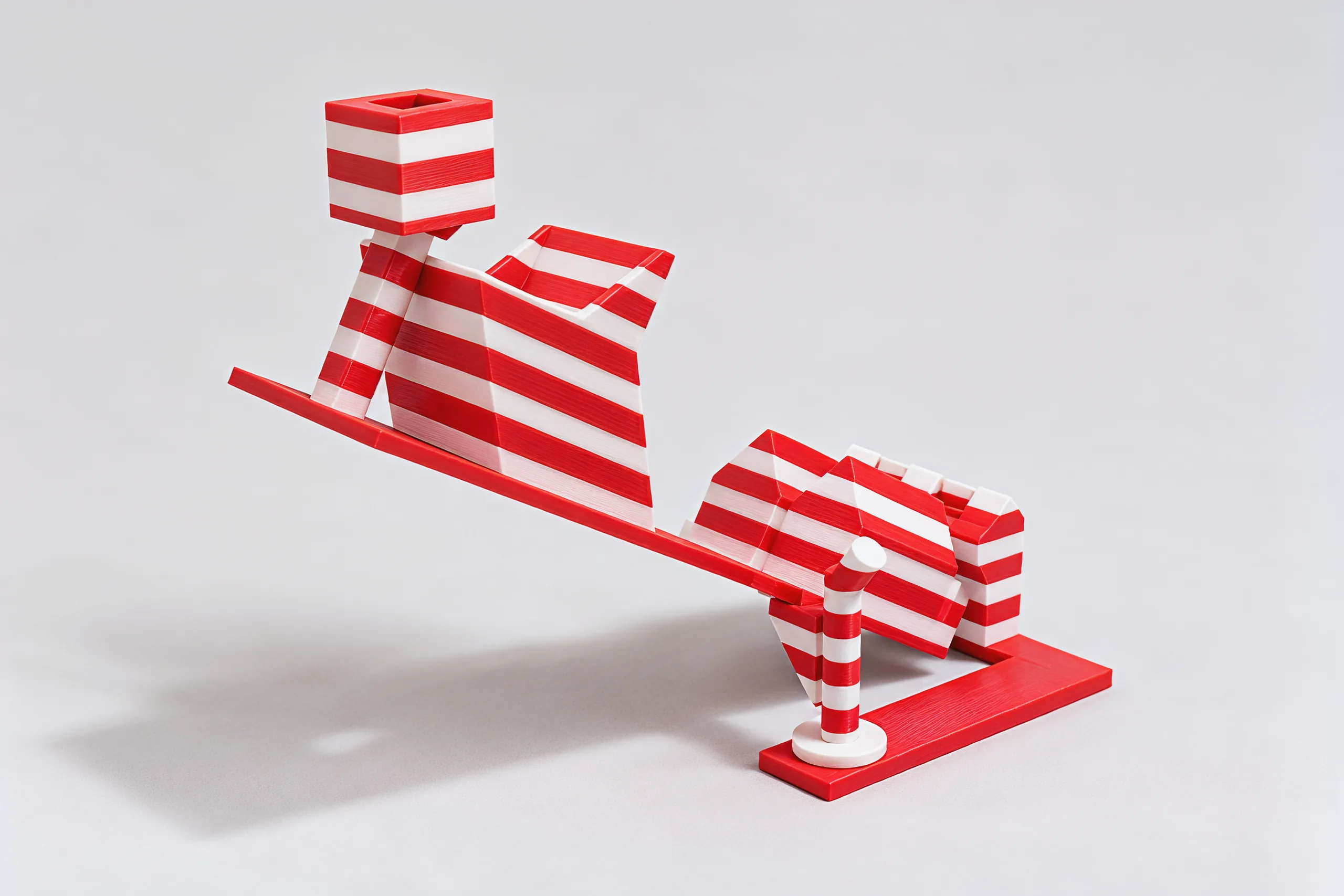 The roof tipped up on its candy cane, the present on its post at the far end, red and white stripes all over