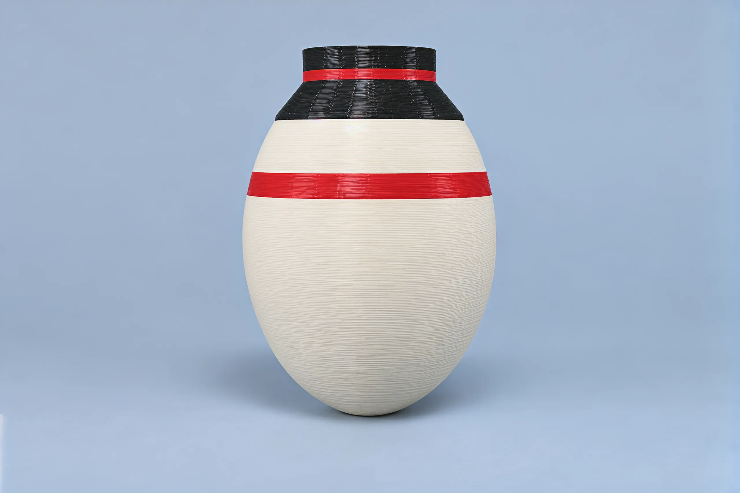 The snowman from behind: the black top hat with its red band, the red scarf going all the way round