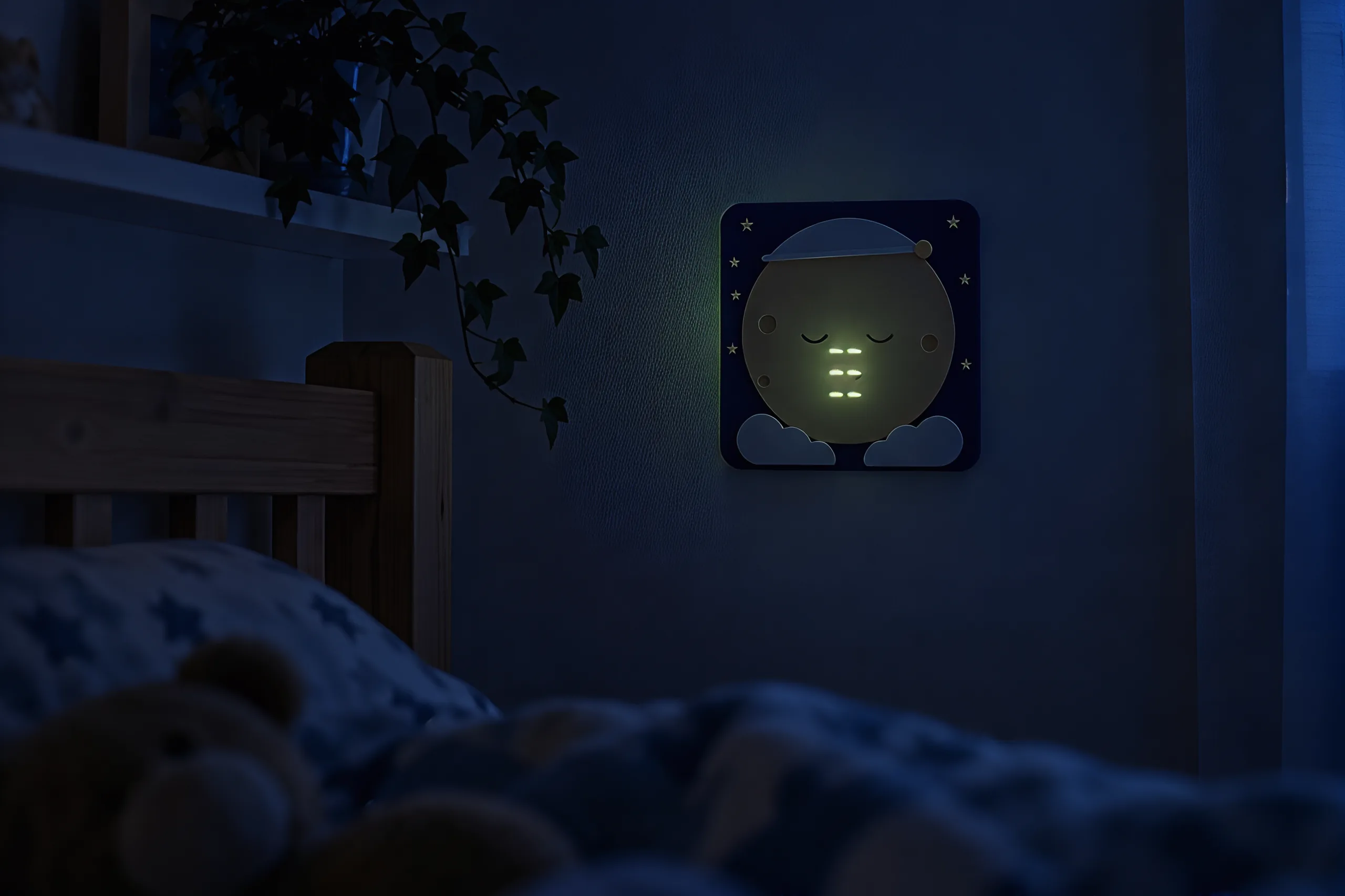 The plaque across a dark bedroom, with faint green light showing through the moon above the bed