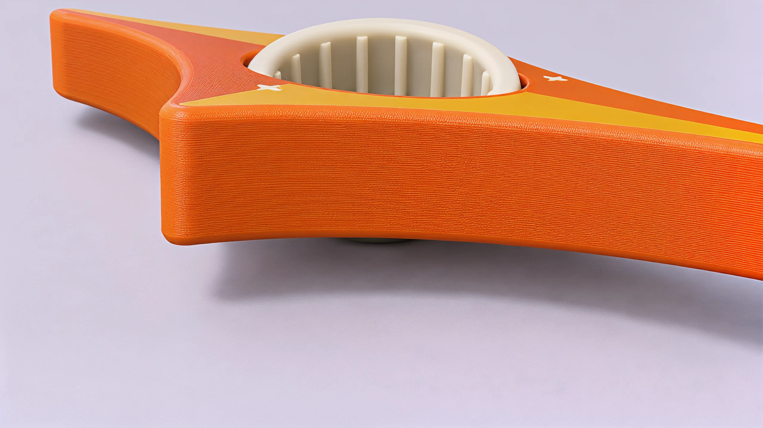 Close on the cream ring, tipped a little in the orange star, the low ribs lining its inside