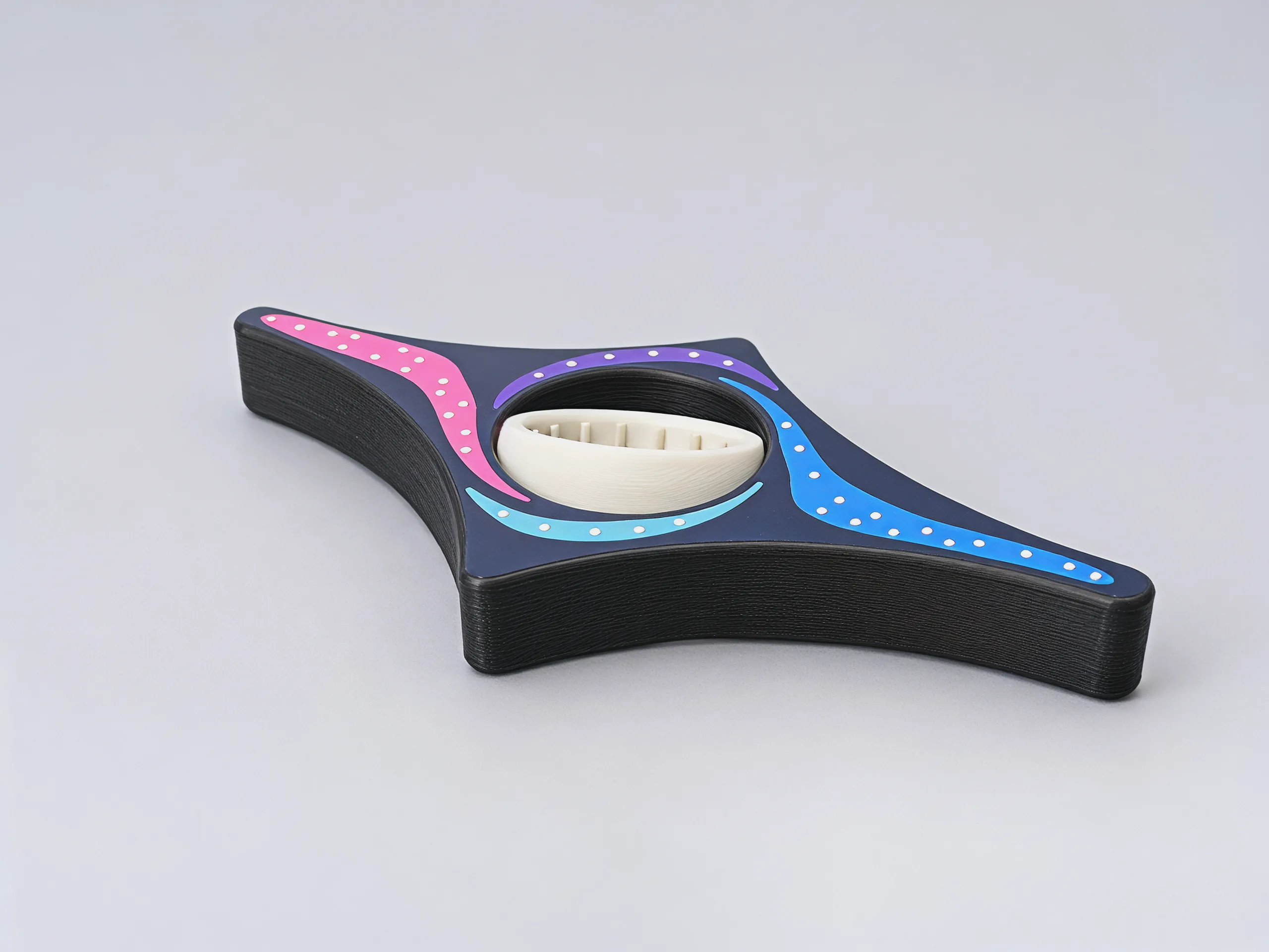 The cream ring tipped over in its round seat while the black frame lies flat, showing the ridges inside the ring